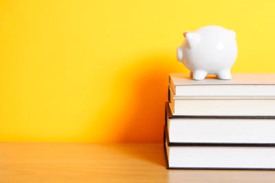 piggy bank on stack of books